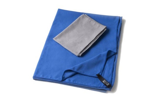 Small gray towel on top of a blue towel.